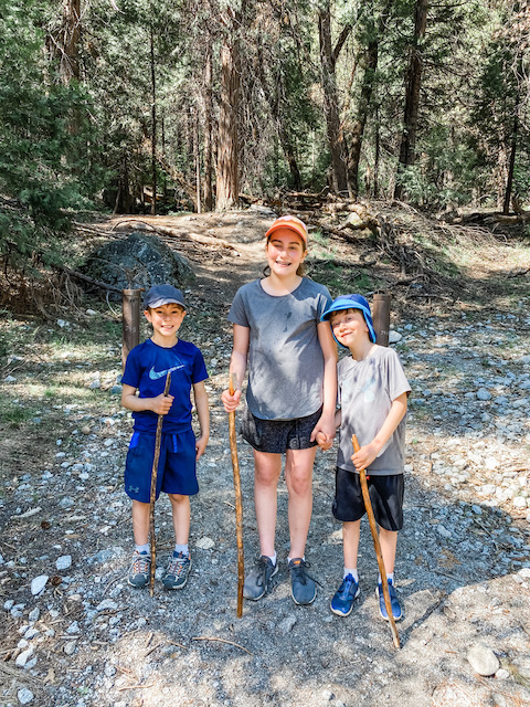 Kids hiking in Yosemite with hiking sticks
